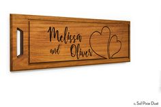 a wooden sign that says meligo and clover with hearts on the front, in black ink