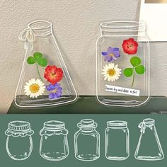 three glass jars with flowers in them sitting on a table next to each other,