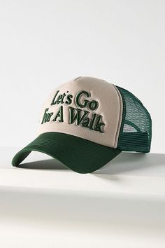 a green and white hat with the words let's go walk on it