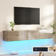 an entertainment center in the living room with a tv mounted on it's wall