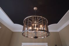 a chandelier hanging from the ceiling in a room