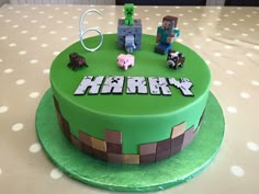 a birthday cake that is made to look like a minecraft theme with animals and blocks on top