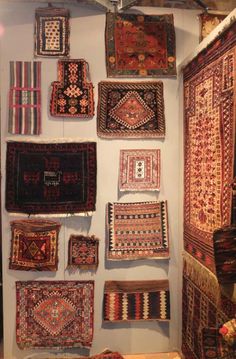 many rugs are hanging on the wall