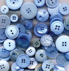 a pile of blue and white buttons sitting on top of each other