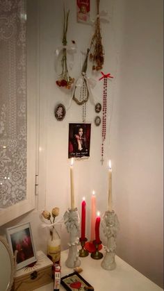 a white table topped with candles and pictures