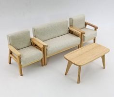 three pieces of furniture sitting next to each other on a white surface with no one in it