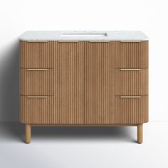 a wooden cabinet with two drawers and a sink in it's center, against a white wall