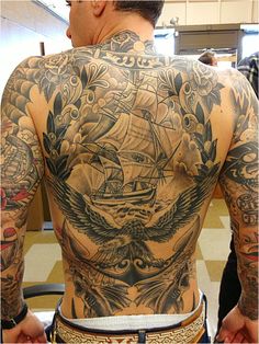 a man with many tattoos on his back