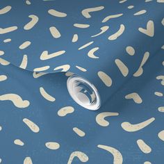 a blue and beige wallpaper with white spots on it's surface, in an abstract manner