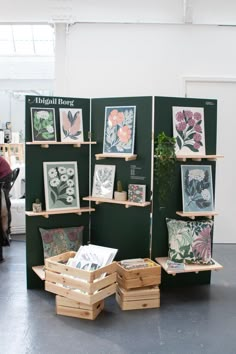 several wooden boxes with pictures and plants on them