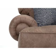 the back end of a couch with blue pillows on it and a brown arm rest