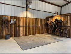 the inside of a horse barn with stalls and tacks on it's walls