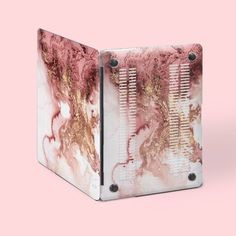 a pink and gold marble binder on a pink background with black metal studs