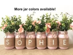 pink painted mason jars with flowers in them that spell out the word, sophiie