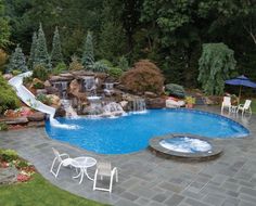 a backyard with a pool, waterfall and patio furniture in the middle is shown from above