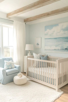 a baby's room with a blue couch and white crib