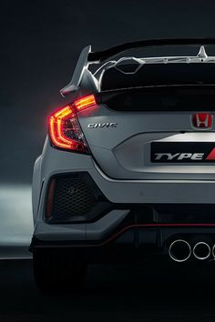 the rear end of a white honda civic type - r with red and black tail lights