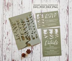 the wedding stationery is displayed with pine cones and paper cutout trees on it