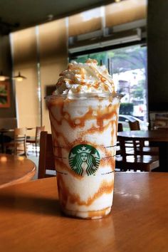 a starbucks drink sitting on top of a wooden table