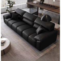 a large black leather couch sitting in a living room