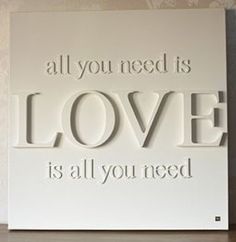 a sign that says all you need is love is all you need on the wall