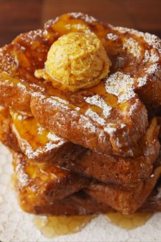 a stack of french toast with powdered sugar on top