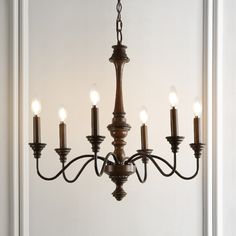 Based on historic wrought iron chandeliers, our rustic 6-light design features a quality wood-look finish. Perfectly sized for a farmhouse dining room, tall entry, or kitchen with high ceilings, our chandelier is just 25" wide and features tall candles with LED candle bulbs. Use this versatile chandelier in a modern farmhouse, French country or Tuscan style home, or to add character to a rustic, industrial space. JONATHAN Y Oakley 25" Rustic 6-Light Oil-Rubbed Black Farmhouse Bare Bulb Chandelie Midcentury Farmhouse, Kitchen With High Ceilings, Tall Candles, Tuscan Style Homes, Century Farmhouse, Modern Farmhouse Dining Room, Wire Installation, Modern Farmhouse Dining, Wrought Iron Chandeliers