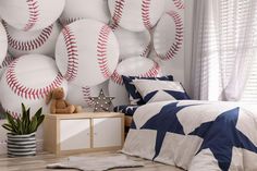 a baseball themed bedroom with white walls and blue stars on the wall, along with a teddy bear