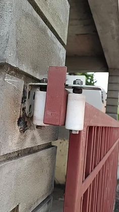 a red and white object on the side of a building