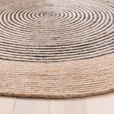 a round rug on the floor with black and white circles in it's center