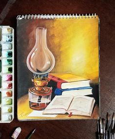 a painting of a lamp, books and paintbrushes on a wooden table next to it