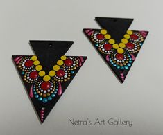 two triangle shaped earrings with colorful beads on them