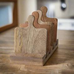 three wooden cutting boards sitting on top of a table