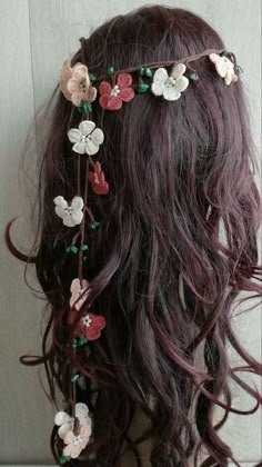 the back of a woman's head with flowers on it