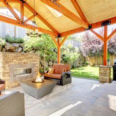 an outdoor covered patio with seating and grill