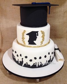 a three tiered cake with a graduation cap on top