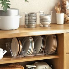 a wooden shelf filled with dishes and cups