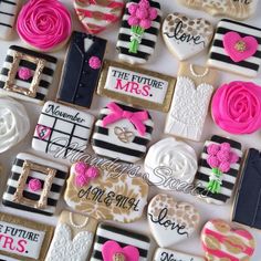 decorated cookies are arranged in the shape of hearts, flowers and other things on display