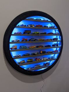 a round display case filled with lots of toy cars