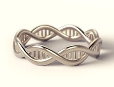 a silver ring with an intertwined design on the front and side, sitting against a white background