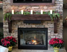 the fireplace is decorated with poinsettis and candles