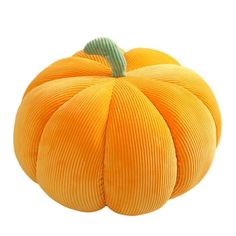 an orange pumpkin sitting on top of a white surface