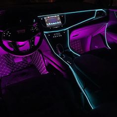 the interior of a car is lit up with purple and blue lights, while the dashboard has