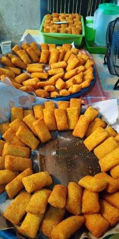 two trays filled with food sitting on top of a table next to each other