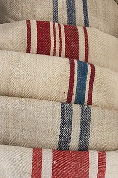 several red, white and blue striped rugs stacked on top of each other