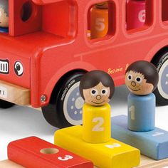 a red toy bus with two children on it