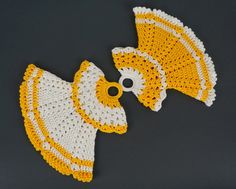 two yellow and white crocheted hats on a table