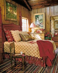 a bed room with a neatly made bed and wooden walls