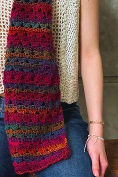 the woman is wearing a multicolored knitted scarf