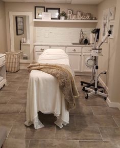 a bed sitting on top of a tiled floor next to a white desk and chair